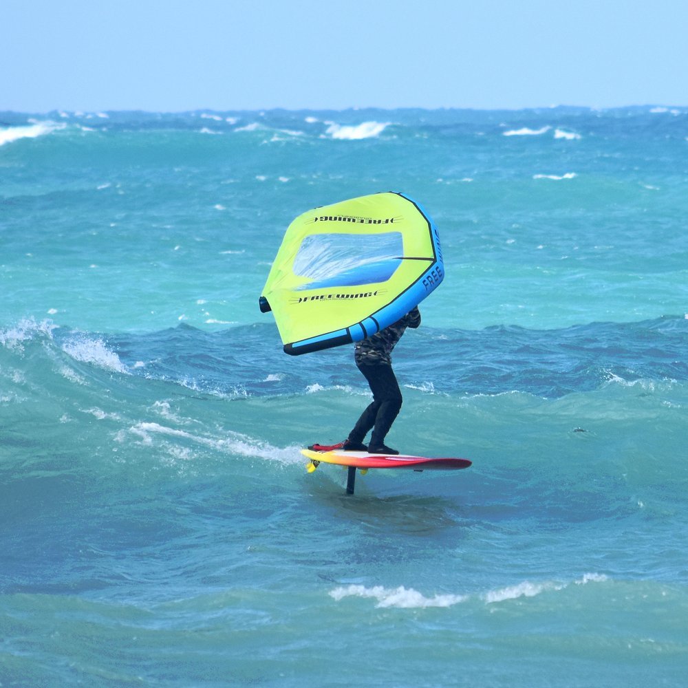 a person riding a wingsurfing board on a wave the ocean